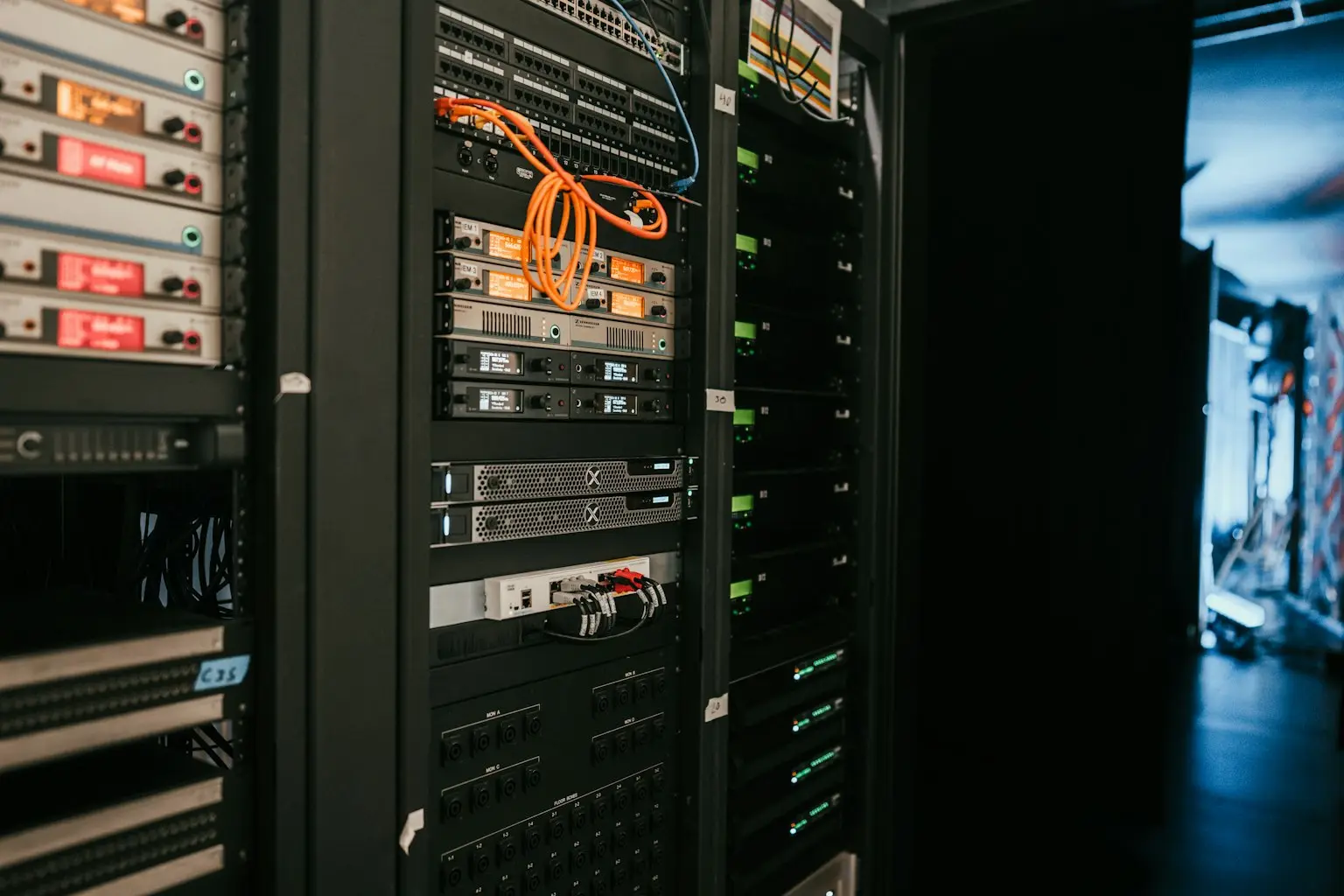 Rows of network and server equipment mounted in a data center rack