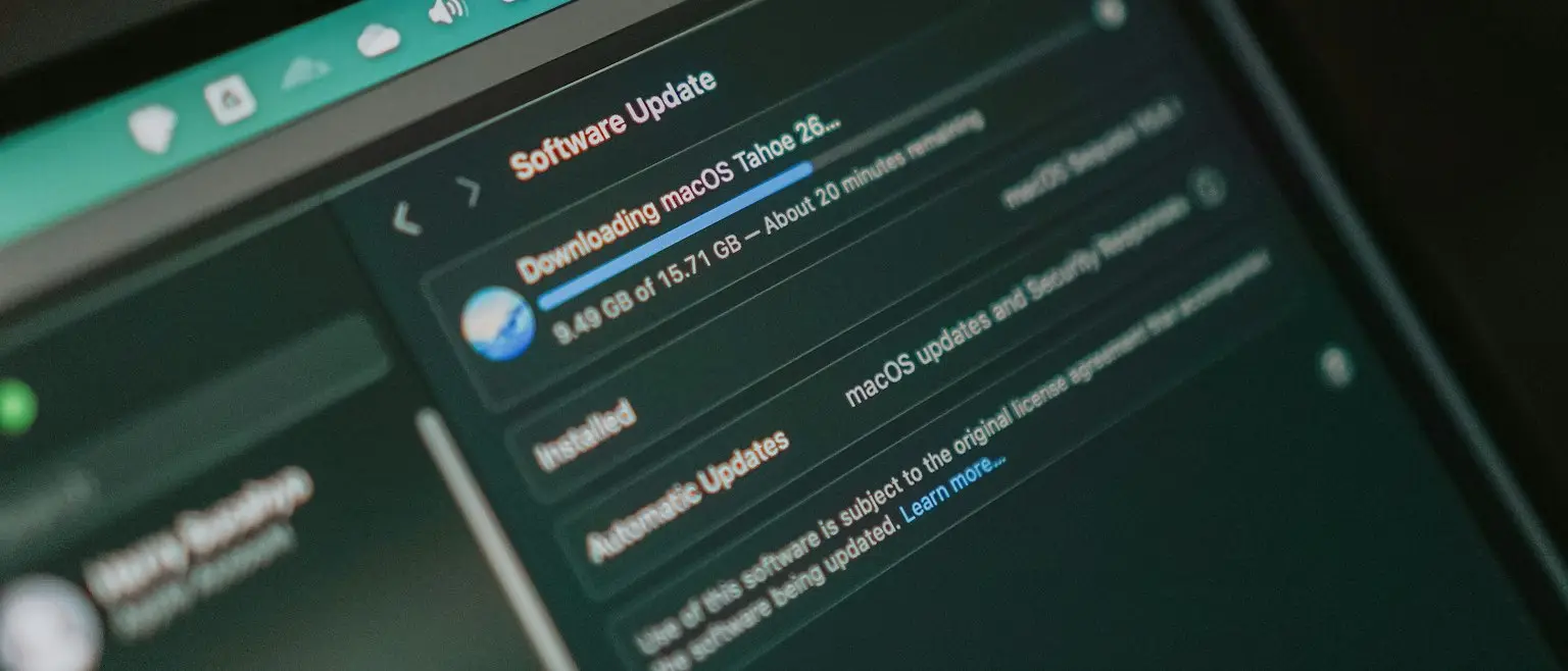 A laptop screen showing an operating system software update downloading